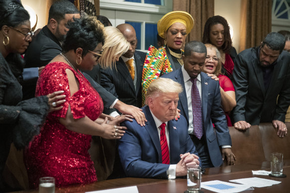 African American leaders say a prayer with then-president Donald Trump in the Cabinet Room of the White House in 2020. Trump’s appeal to religious conservatives is a cornerstone of his political identity.