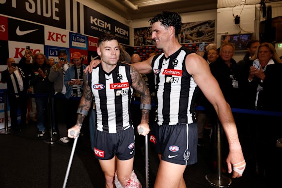 Jamie Elliott and Scott Pendlebury in the rooms post-game.