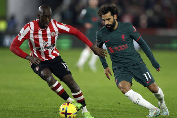 Liverpool’s Mohamed Salah, right, duels for the ball with Brentford’s Yoane Wissa.