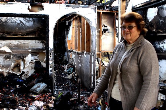 Joan Graham in the ruins of her home after fire destroyed it in 2012.