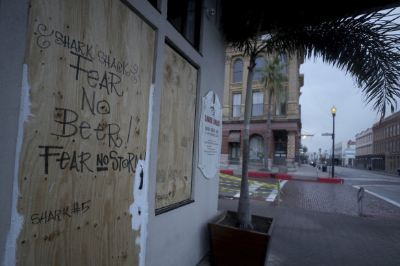 The Shark Shack Beach Bar and Grill is boarded up on Strand Street in Galveston.