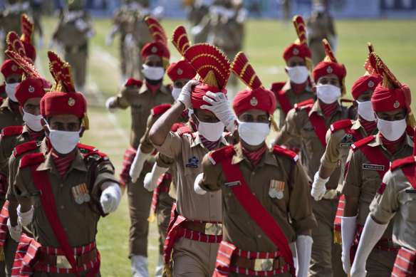 Police in Srinagar in Indian-controlled Kashmir wear face masks during rehearsals for India's Independence Day ceremony.