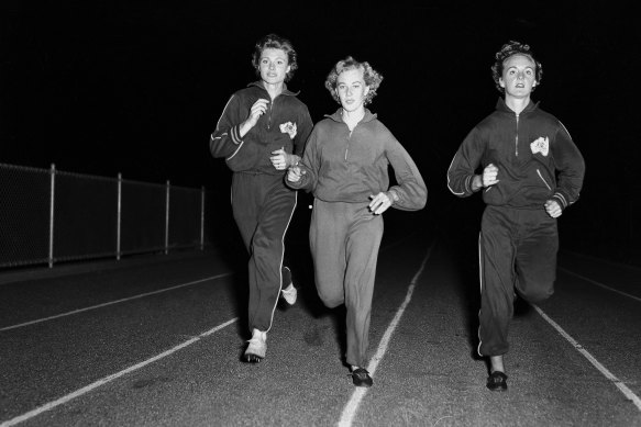Marlene Mathews, left, trains with Kay Johnson and Gloria Cooke at the E.S. Marks Athletics field in Sydney’s Kensington on March 25, 1958.