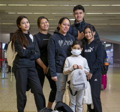 Moving back to Brissie: Meriana Ferris, centre, and her children at Melbourne Airport.