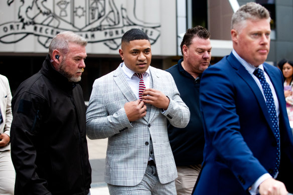 Sidelined Manly Sea Eagles hooker Manase Fainu leaves Parramatta District Court, flanked by security guards and his lawyer, after the guilty verdict.