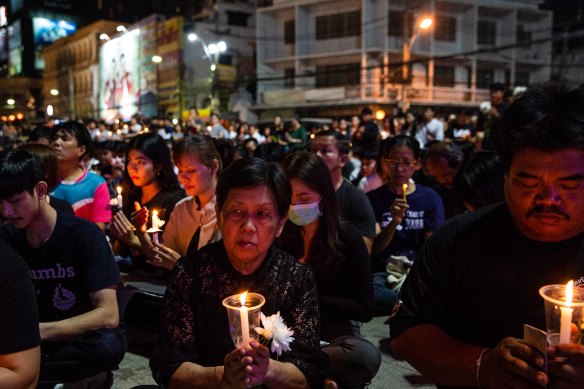 Mourners attend a candlelight vigil for the victims of Thailand's worst mass shooting.