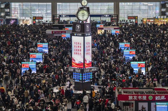 Travellers crowd at the gates and wait for trains at the Shanghai Hongqiao Railway Station during the peak travel rush for the upcoming Chinese New Year holiday on January 15.