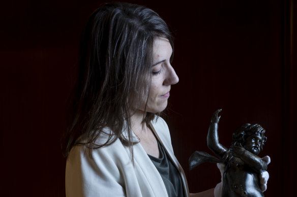 Tomasina Ray, head of collections at RMS Titanic, with the cherub artefact from the staircase of the Titanic.
