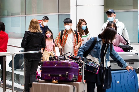 Travellers arriving at Sydney International Airport on Sundy. All international arrivals have to self isolate for 48 hours due to the Omicron variant.