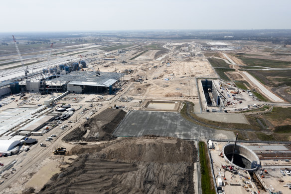 The massive rectangular hole for the airport station is several hundred metres from the terminal, while a large shaft has been dug nearby to support logistics for tunnel boring machines.
