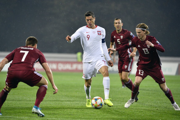 Poland's Robert Lewandowski (centre) in action against Latvia.