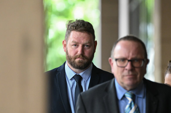 Police officer Beau Barrett (left) leaves Melbourne Magistrates’ Court on Monday.