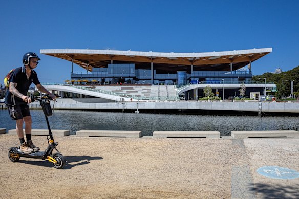 An e-scooter rider passes the new Sydney Fish market.