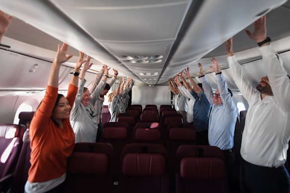 Passengers, including then-CEO Alan Joyce (second from right), exercise during a Project Sunrise test flight from London to Sydney in 2019.