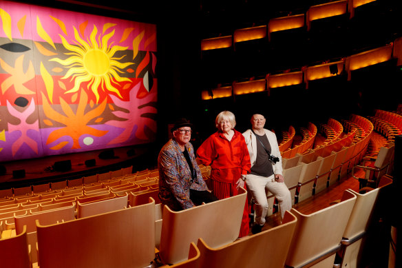 Stephen Coburn, Kristin Coburn and Daniel Coburn in front of their father John Coburn’s artwork Curtain of The Sun in the Joan Sutherland Theatre within the Sydney Opera House