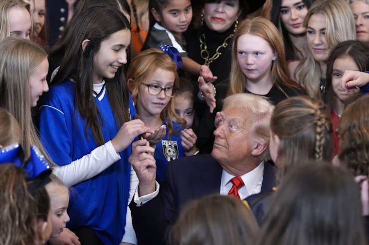 President Trump hands out pens after signing an executive order on transgender athletes.