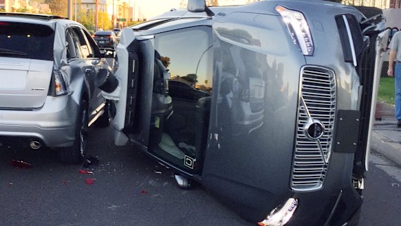An Uber self-driving car that flipped on its side in a collision in Arizona.