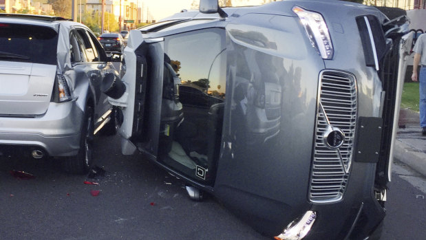 An Uber self-driving car that flipped on its side in a collision in Arizona.