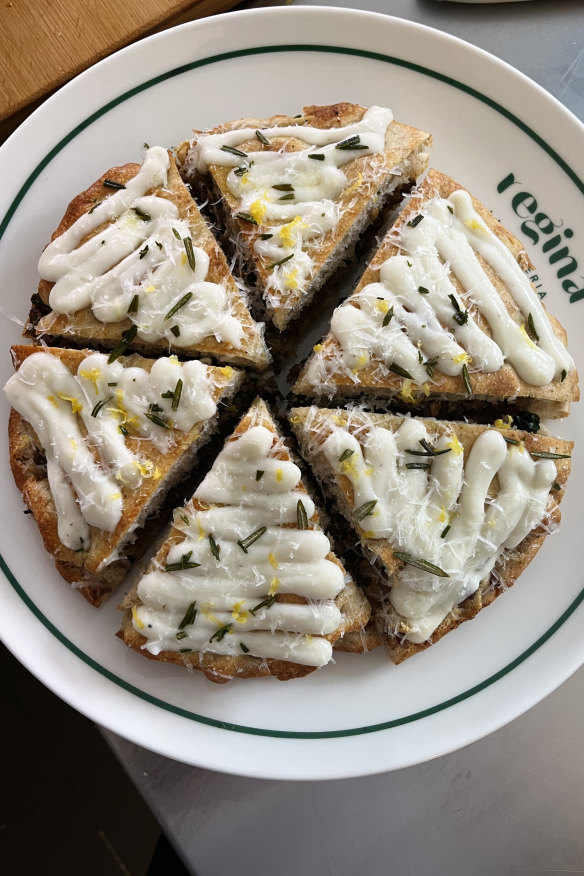 Regina La Pizzeria’s ‘Mina’ Padellino (pan-baked pizza) with white bolognese, rosemary, parmesan, finished with pecorino sauce and lemon zest.