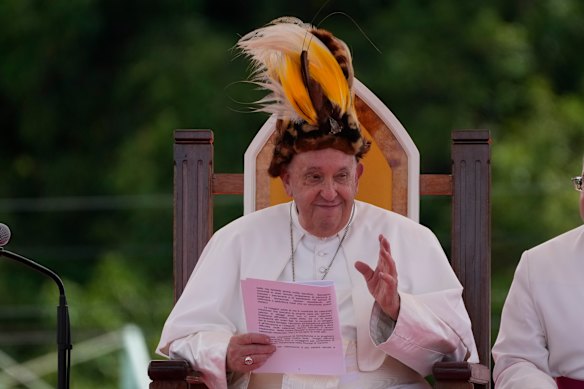 Wearing a traditional hat during a meeting with the faithful in Vanimo, Papua New Guinea, on September 8, 2024.