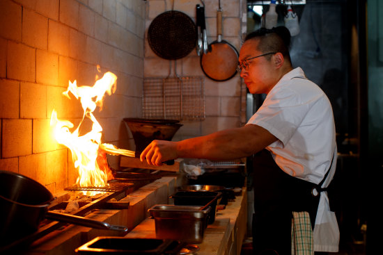 Co-founder and chef Raymond Hou works the new grill at Firepop, Enmore.