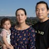 p5o02v. Emily Hurry, with her daughter Eliza and partner Oliver ke Duan on the balcony of their Wentworth Point apartment, with construction work on the new Melrose Park light rail stop visible in the background. They moved to Wentworth Point on the promise of Stage 2 of the Parramatta Light Rail connecting the dense suburb to the rest of Sydney via the new Metro. But now the government has halved its project and has put no timeline on the final completion date. Saturday 7th February 2026. Photo: Sitthixay Ditthavong
