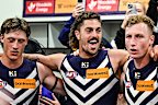 Luke Jackson, Jye Amiss and Josh Treacy sing the Fremantle song after a win.