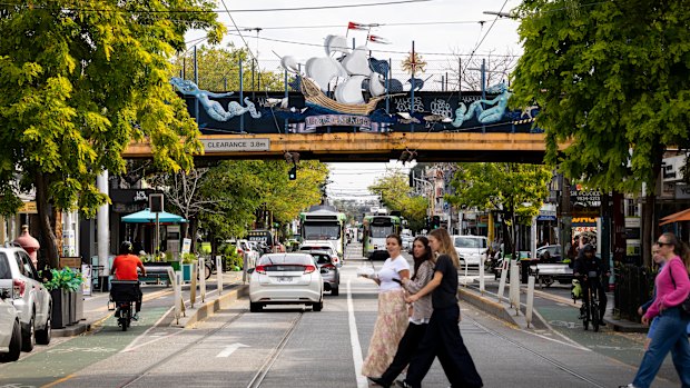 The train bridge north of Balaclava station as it crosses Carlisle Street, featuring the Lady of St Kilda art work.