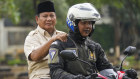 Prabowo Subianto (left) is taken to his father’s grave in Jakarta on Thursday.