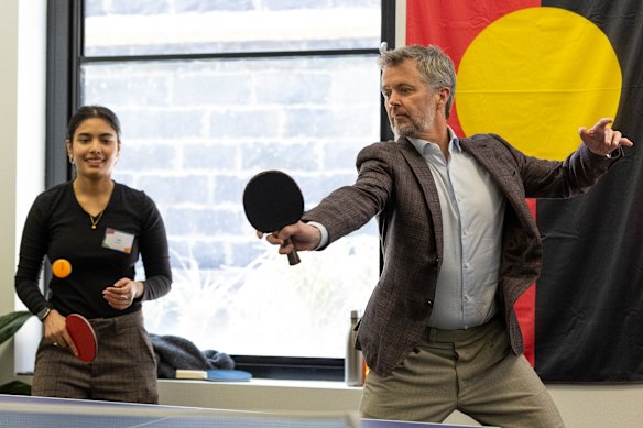 King Frederik plays table tennis during a visit to Headspace South Melbourne, opting in after declining a kick of the footy earlier in the week. The result was decisive — a first-to-five loss.
