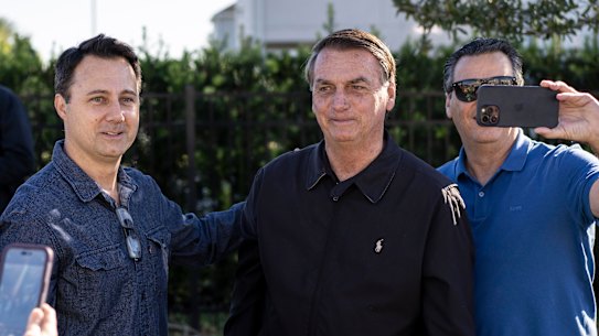Former Brazilian president Jair Bolsonaro greets people outside the home where he’s staying in Kissimmee, Florida, on January 8