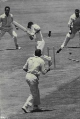 Bails fly as Alan Davidson bowls Englishman Fred Titmus in 1963.