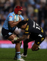 Langi Gleeson breaks a tackle against the Hurricanes.