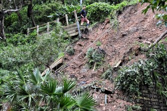 A resident looks over a landslide at Narrabeen on the northern beaches.