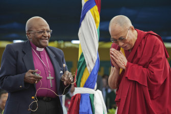 Anglican Archbishop Emeritus Desmond Tutu, left, and Tibetan spiritual leader the Dalai Lama interact with children at the Tibetan Children’s Village School in Dharmsala, India, in 2015.