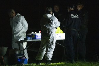 Forensics technicians at the Benaroon Drive home in Kendall.