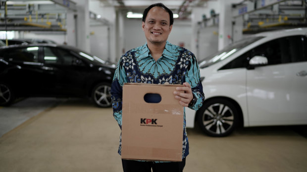 KPK official Mungki Hadipratikno stands before confiscated cars at the anti-corruption agency’s new storage facility in Jakarta.