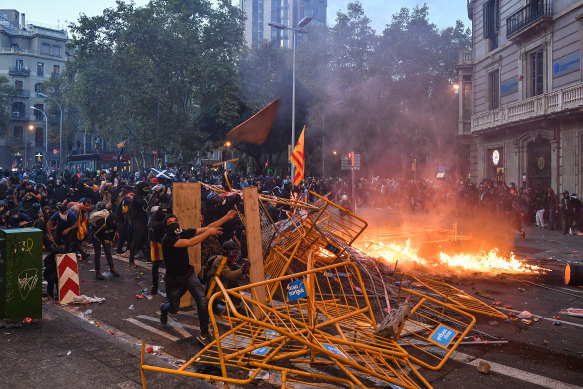 Protesters throw objects as a general strike is called following a week of protests over the jail sentences given to separatist politicians by Spain's Supreme Court.