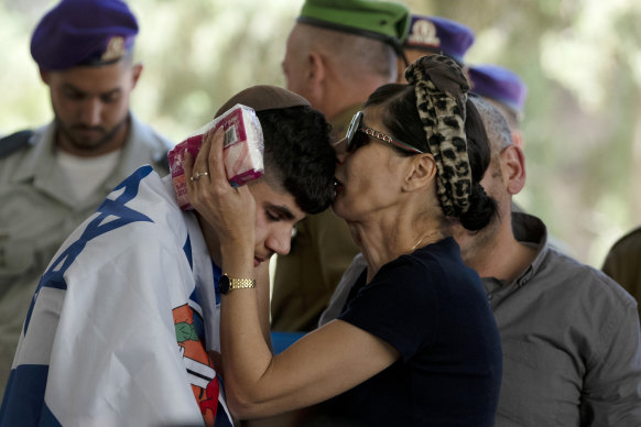 Harel Elias is kissed by his mother, Shlomit, on Friday after giving a eulogy at the funeral for his brother, Israeli Army Sargent Yonatan Elias, who was killed in bettle in the Gaza Strip.