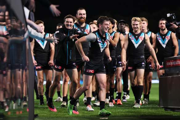 Connor Rozee and Zak Butters lead their side off the ground after their win over St Kilda.