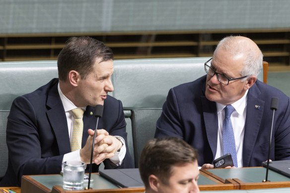 Alex Hawke and Scott Morrison sit next to each other in parliament, reflecting their longstanding political friendship.