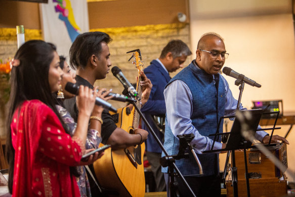 Pastor Mohit Sampson (in blue) leading his congregation at Masih Church in Melton.