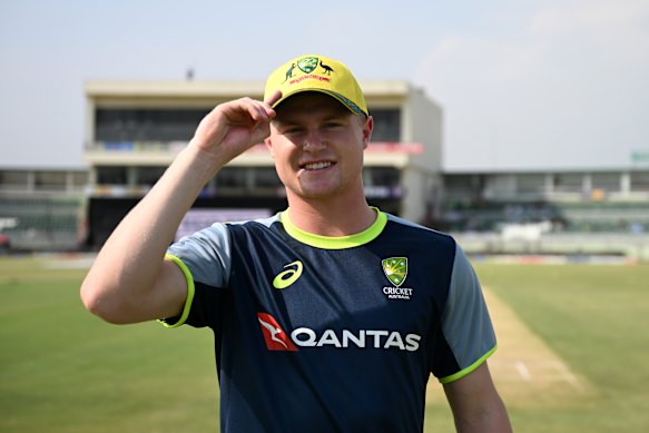 Ollie Peake tries on his new Australian cap before play.