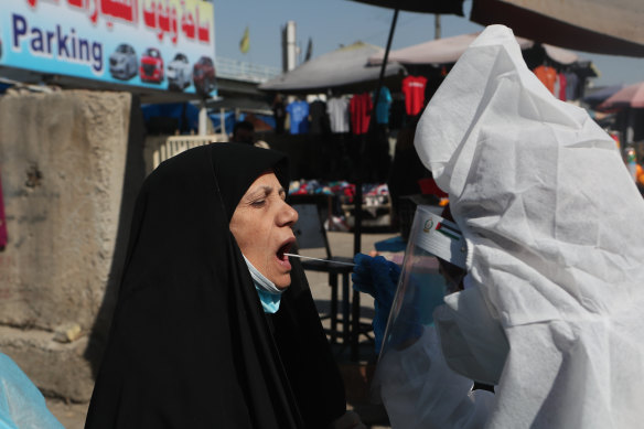 A woman is tested for COVID in Baghdad in February. The nation is still enduring repeated coronavirus outbreaks. 