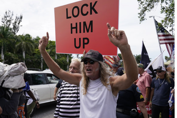 Demonstrators rally outside the Trump National Doral resort.