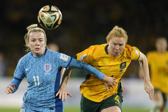 Australia’s Clare Polkinghorne and England’s Lauren Hemp challenge for the ball during the semi-final.