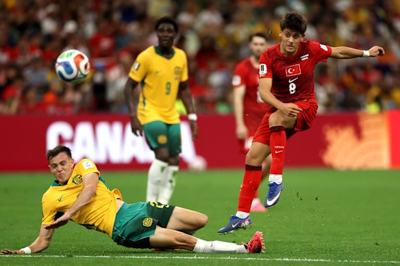 Arda Guler shoots while Paul Okon jnr attempts to block the ball.