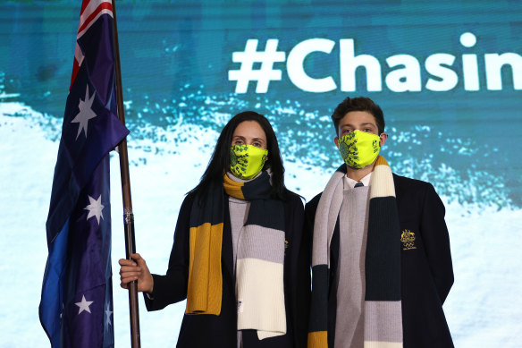 Aerial skier Laura Peel (L) and figure skater Brendan Kerry (R) of Team Australia pose with their national flag. 