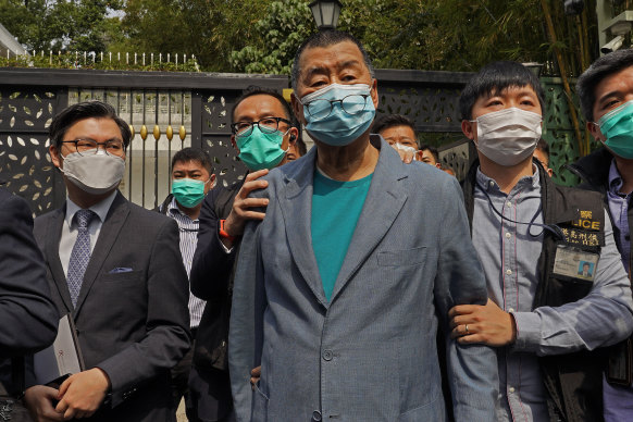 Apple Daily founder Jimmy Lai, centre, was arrested in April last year.