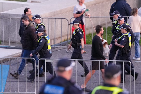 Police lead away white supremacist Jacob Hersant, who heckled the Welcome to Country  at the dawn service at Melbourne’s Shrine of Rememberance.